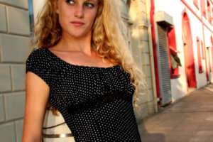 blond model posing in black and white polka dot top