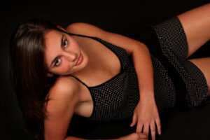 model posing in black and white polka dot dress in photographic studio